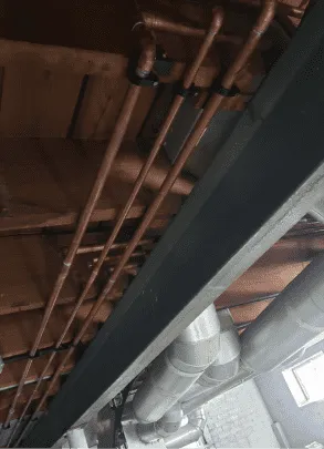 Expertly Installed Copper Pipes in the Ceiling by Iron Plumbing.